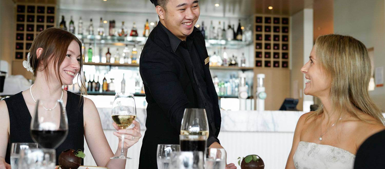 Il Piatto - Waiter serving dessert to guests at table